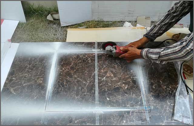 Tile Saw Blade - Man Worker cutting a tile using an angle grinder close up