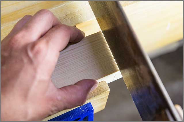 hand using Japanese handsaw