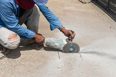 Shows worker cutting stone