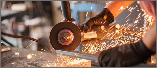 A hand-held circular saw grinding through steel