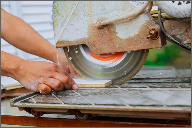  A tile saw blade midway through cutting a porcelain tile