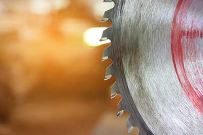 Metal Circular Saw Blade on a Wooden Background
