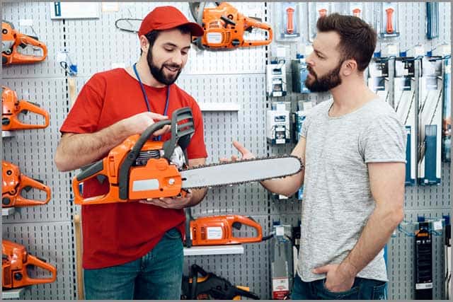 Saw Blade Manufacturers: A salesperson showing a chainsaw to a customer