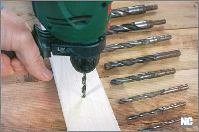 Making a hole into a wood with a drill bits