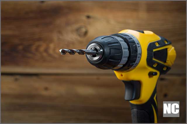 Electric drill on a wooden background