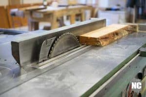 A table saw showing its guardrail and saw blade