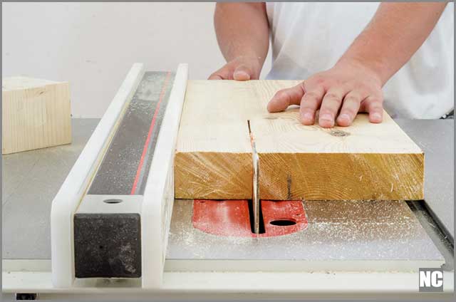 Rip-cutting a wood on a table saw.