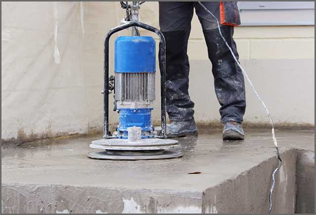 Worker running the grinding machine at moderate speed