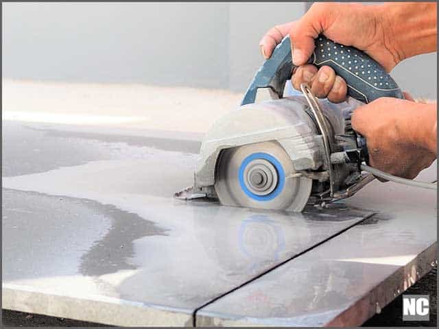 Close up worker use wet sawing machine for cutting marble stone