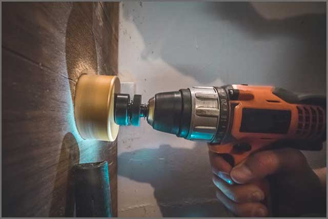 Hand power drill in operation with the core bit