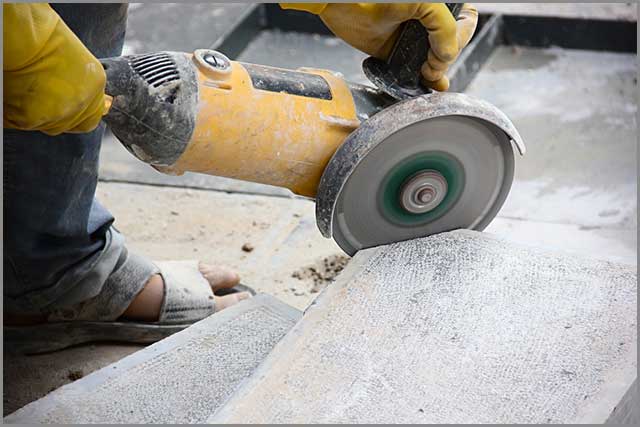 A worker cutting stone