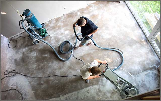 Workers seen polishing concrete floor