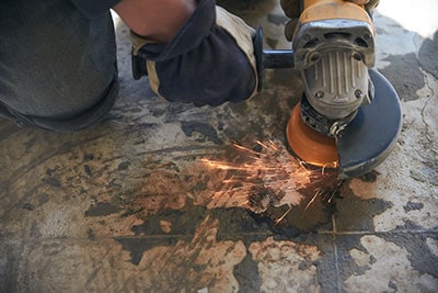 A handyman using an angle-grinder