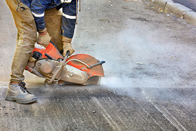 Concrete cutting operation ongoing.