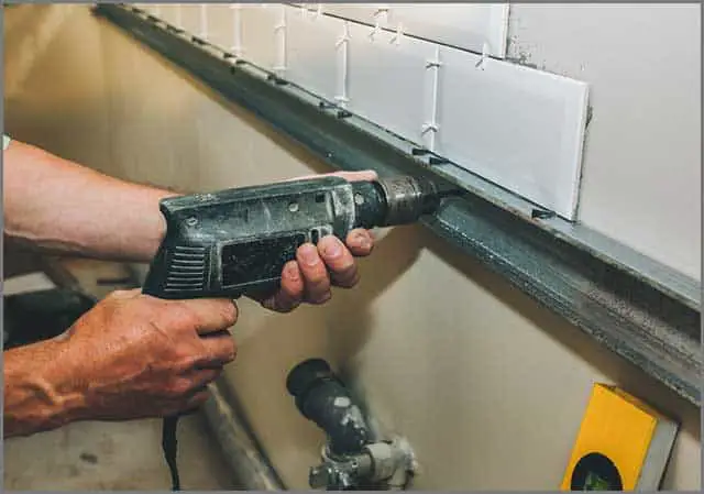 Man applying pressure on tile cutting