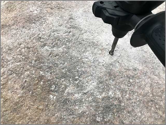 Drilling a granite rock with a metal core drill bit