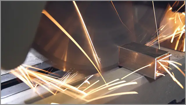 Cold saw blade in operation with sparks