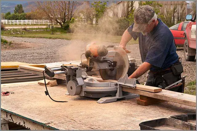 A construction worker cutting board with a sliding miter saw