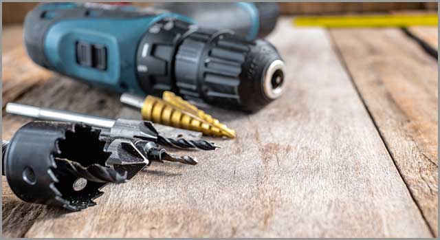 A Hole Saw and a Set of Drill Bits