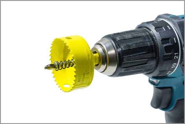 A Hole Saw Attached to a Hand-held Drill