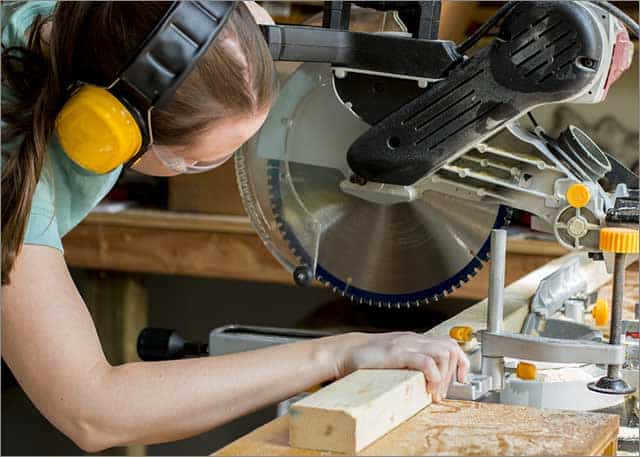 A dual bevel sliding compound miter saw while operating