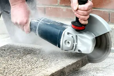 A professional using an angle grinder