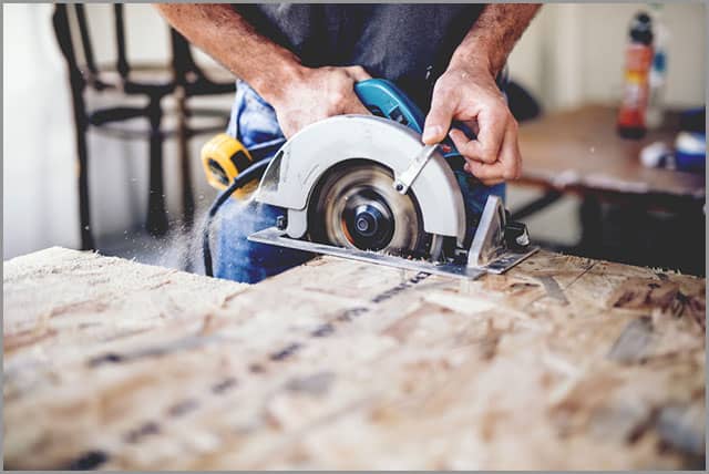 How to Cut Wood--A carpenter cutting wooden board with a circular saw