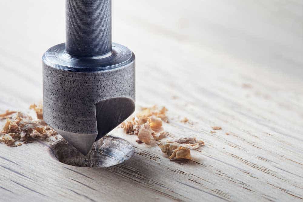 A countersink drill bit drilling a hole