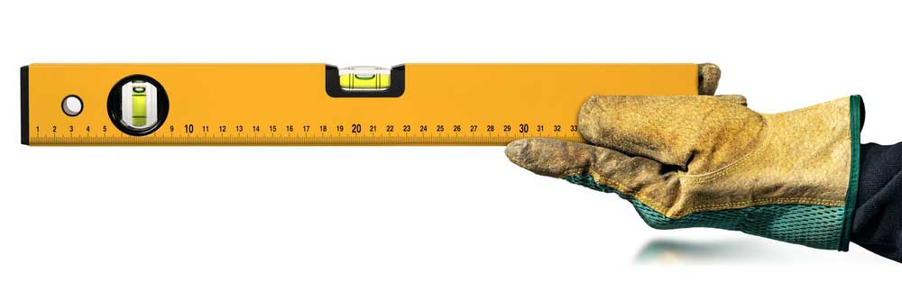 Masonry Spirit Level Held in a Gloved Hand