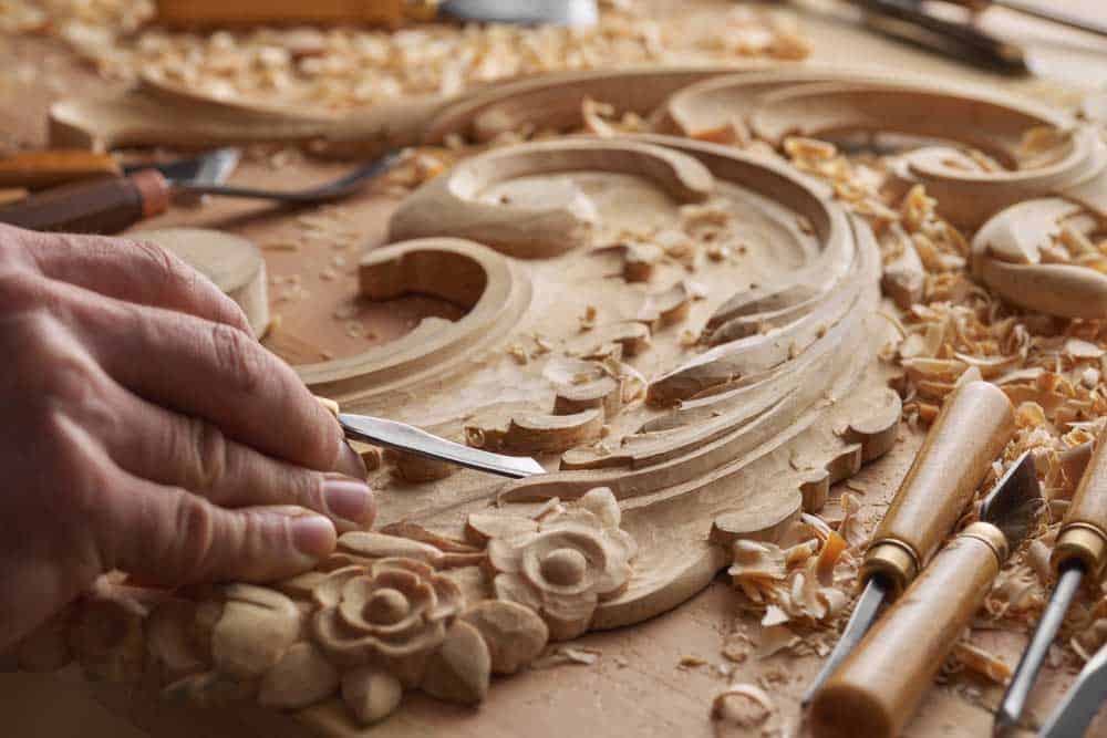 Man Carving Wood By Hand