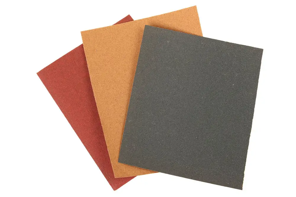 A range of different abrasive grains on sandpaper.