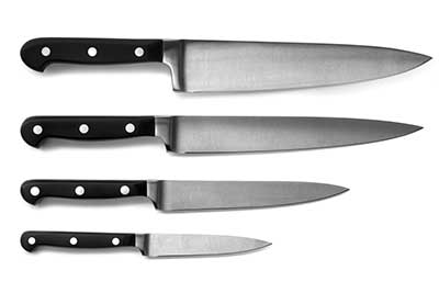 A set of kitchen knives rests on a white background.