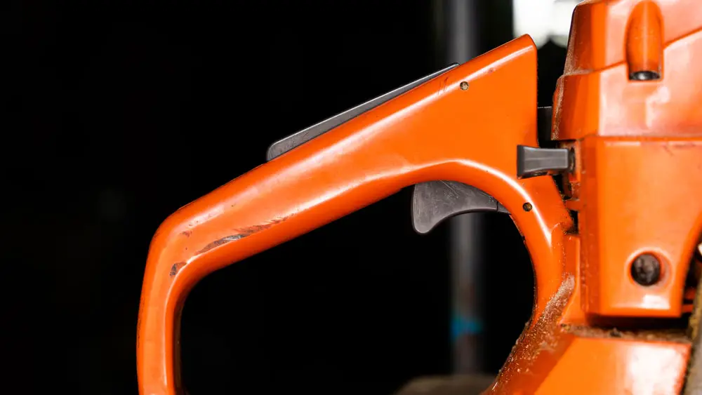 Close view of chainsaw handle
