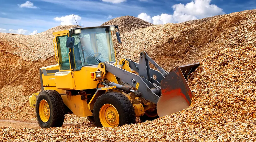 The digger is pushing sawdust